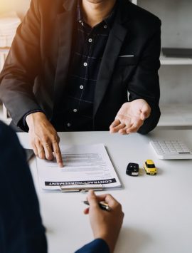 car-rental-company-employee-is-handing-out-car-keys-renter-after-discussing-rental-details-conditions-together-with-renter-signing-car-rental-agreement-concept-car-rental_265022-32374