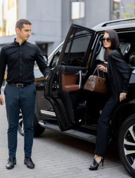 male-driver-helps-business-lady-get-out-car_506452-22440